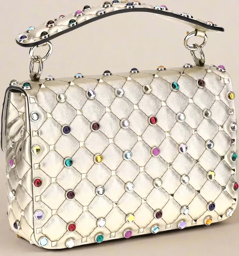 Quilted handbag with colorful gemstones on a white background