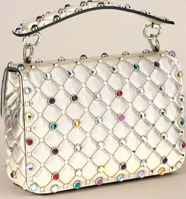 Quilted handbag with colorful gemstones on a white background