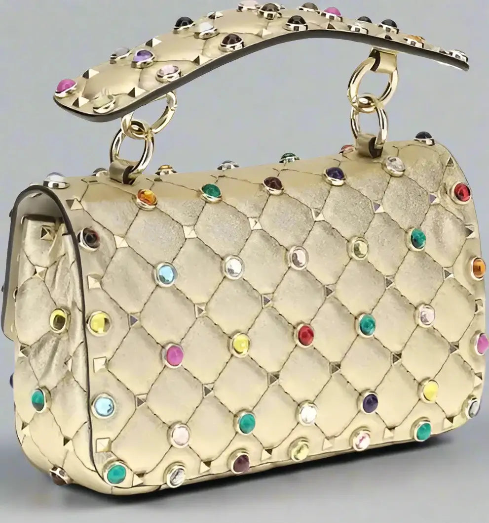 Gold handbag with colorful gemstones on a white background