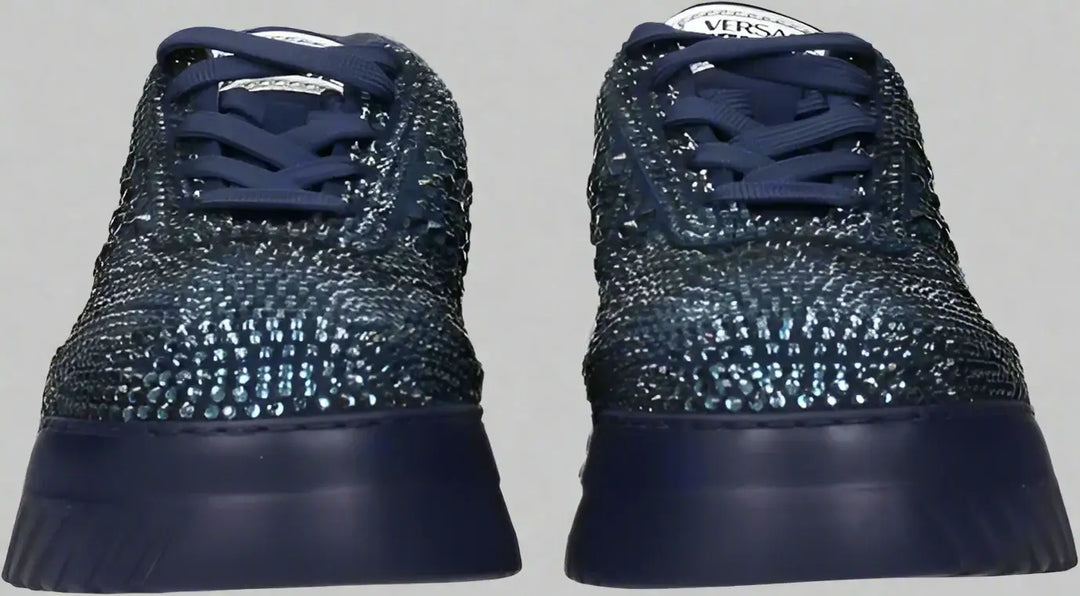 Navy blue sneakers with textured design on a white background