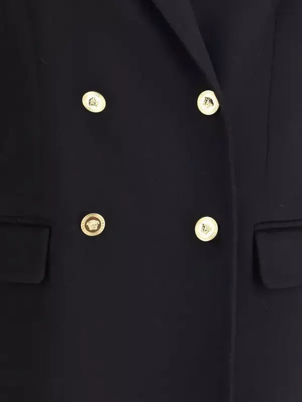 Close-up of a black coat with gold buttons