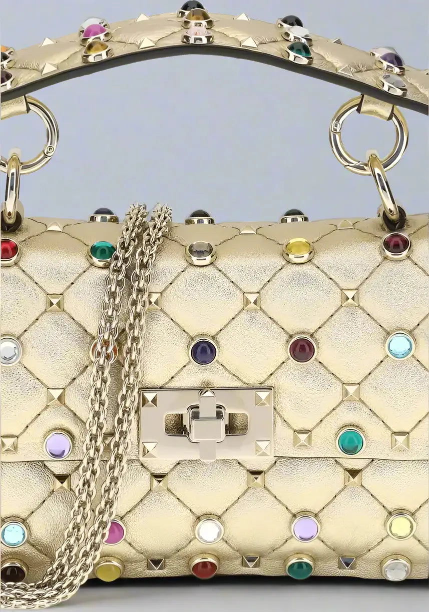 Gold handbag with colorful gemstones and a chain strap