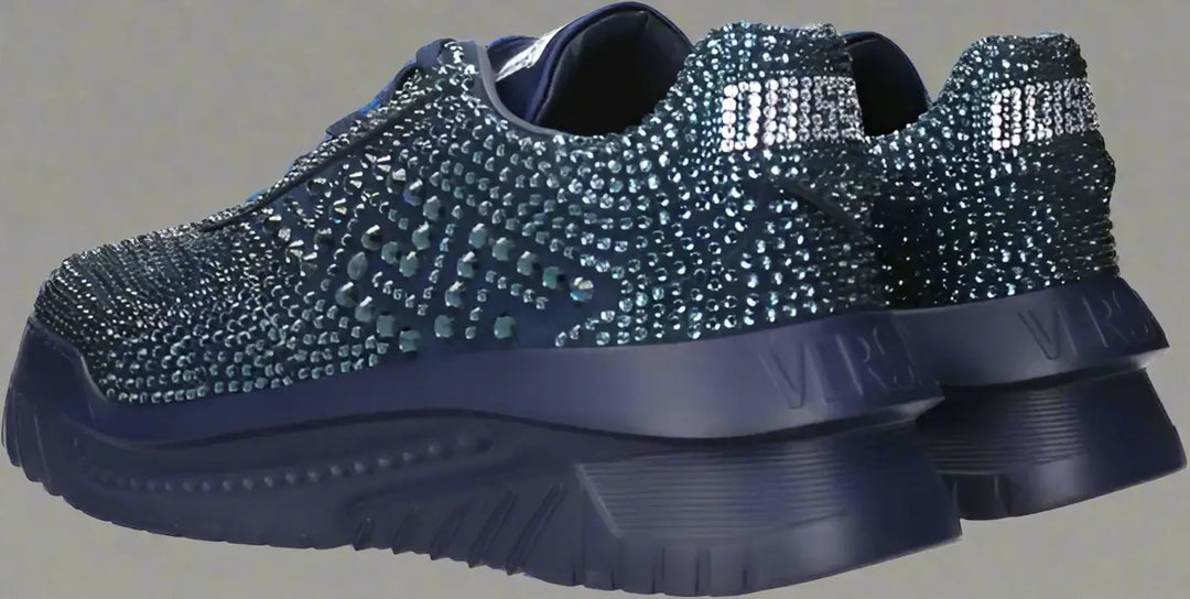 Blue sneakers with rhinestone embellishments on a white background