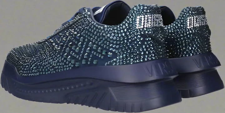 Blue sneakers with rhinestone embellishments on a white background