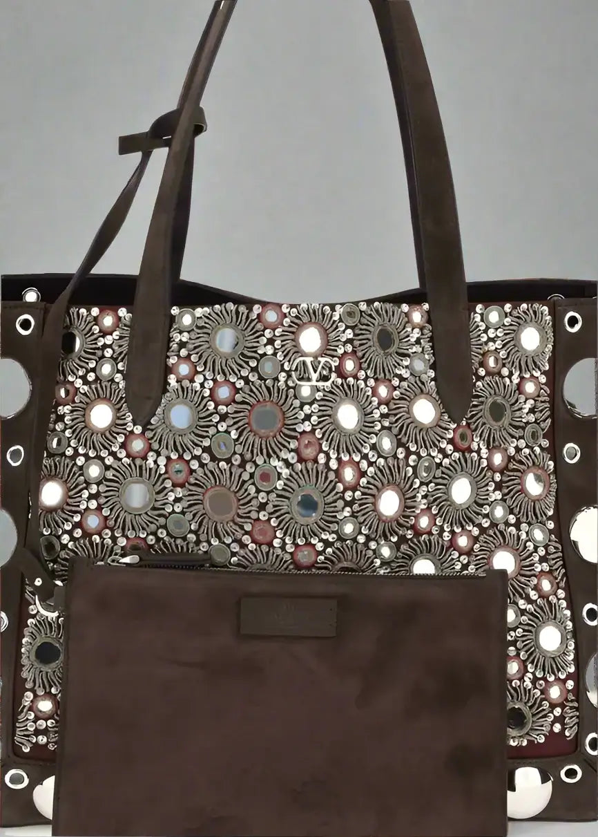 Brown tote bag with floral pattern and decorative elements on a white background