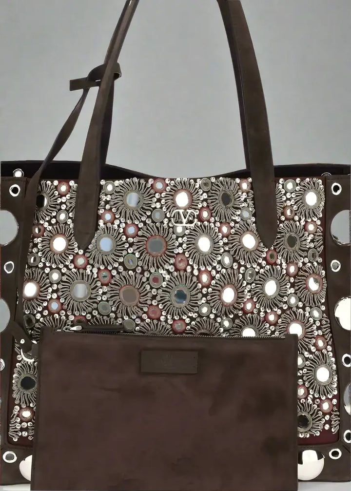 Brown tote bag with floral pattern and decorative elements on a white background