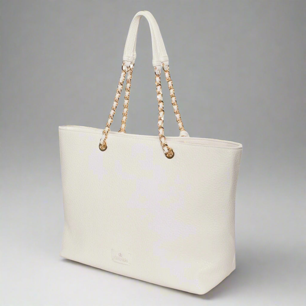 White tote bag with gold chain handle on a white background