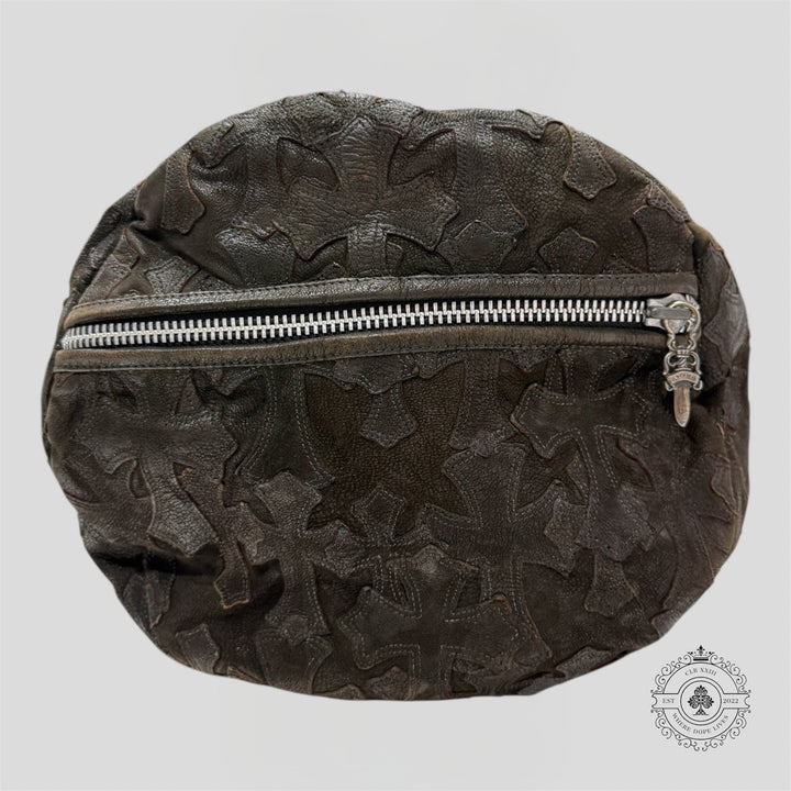 Dark brown leather bag with floral patterns and a silver zipper on a light gray background.
