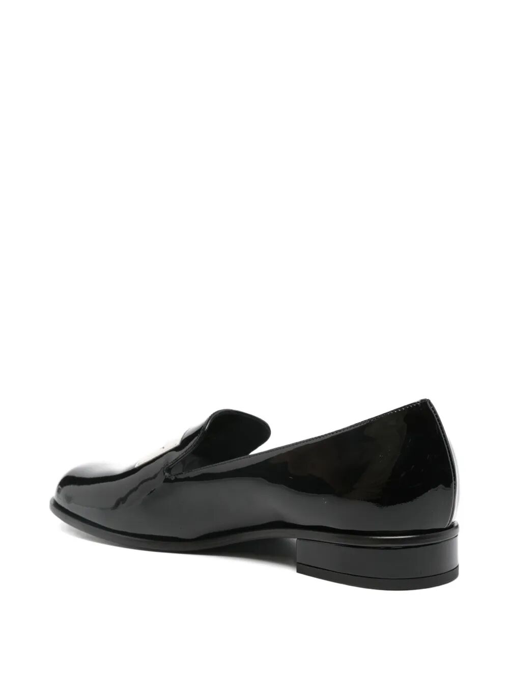 Black patent leather loafer on a white background