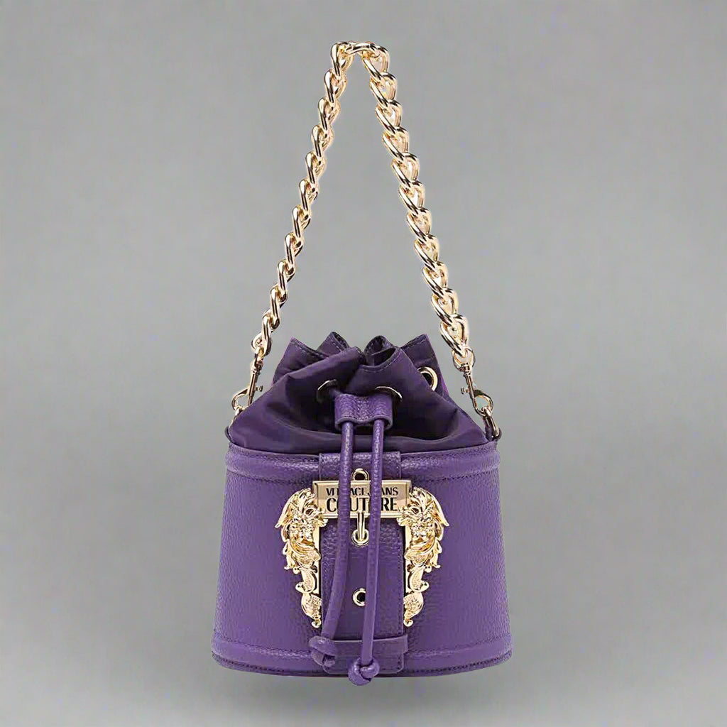 Versace Jeans Couture purple shoulder bag with gold emblem, drawstring design, stylish synthetic leather handbag.