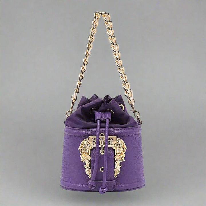 Versace Jeans Couture purple shoulder bag with gold emblem, drawstring design, stylish synthetic leather handbag.