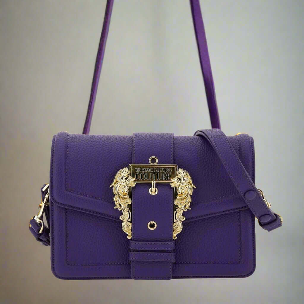 Purple handbag with gold accents on a white background