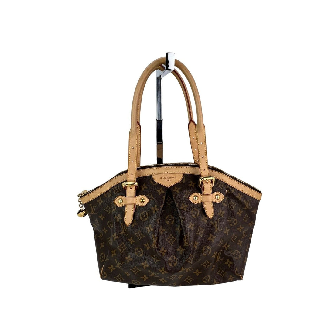 Designer handbag with monogram pattern on a white background