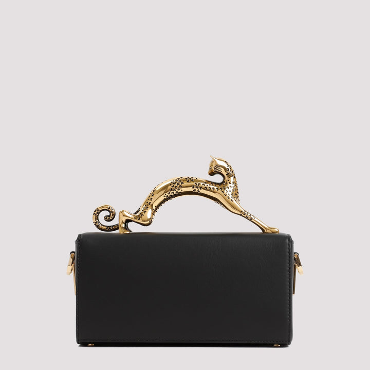 Black handbag with gold handle on a light gray background