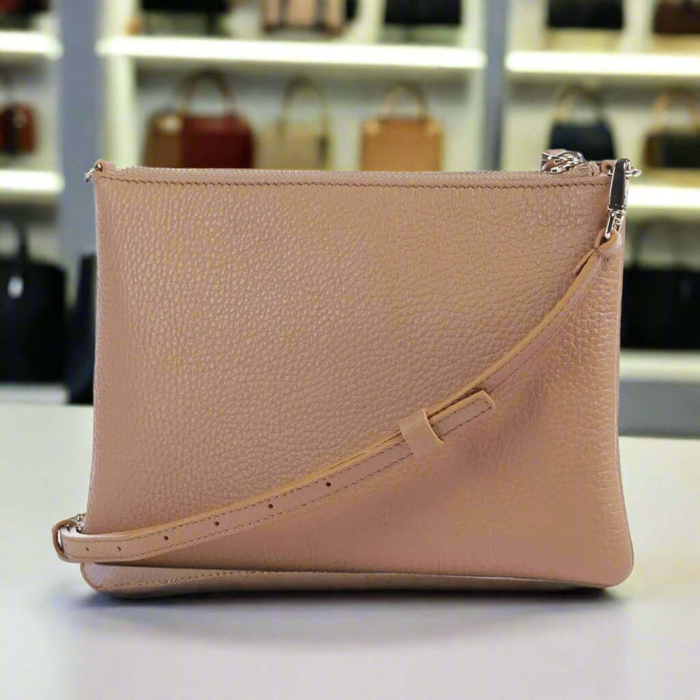 Beige leather crossbody bag on a white background