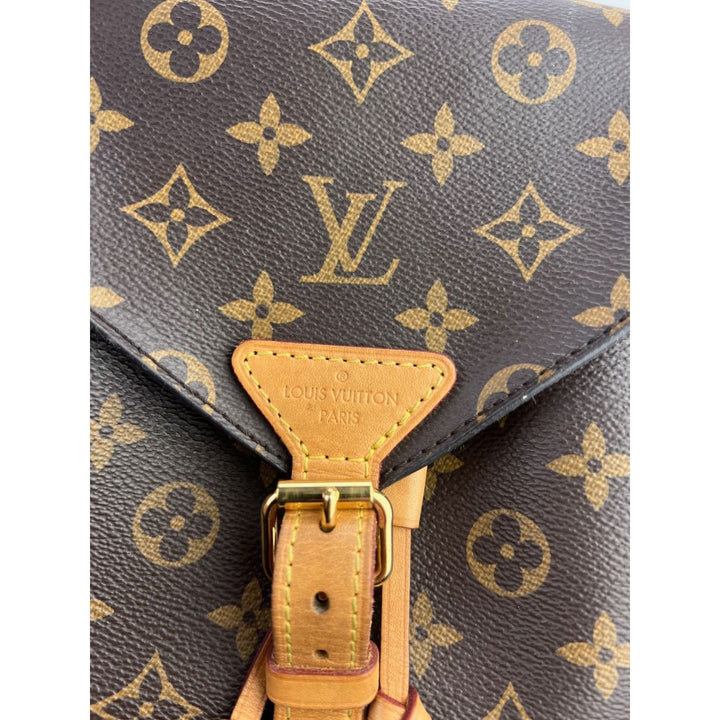 Close-up of LOUIS VUITTON Montsouris NM Monogram Backpack showcasing the logo and leather details on the exterior.