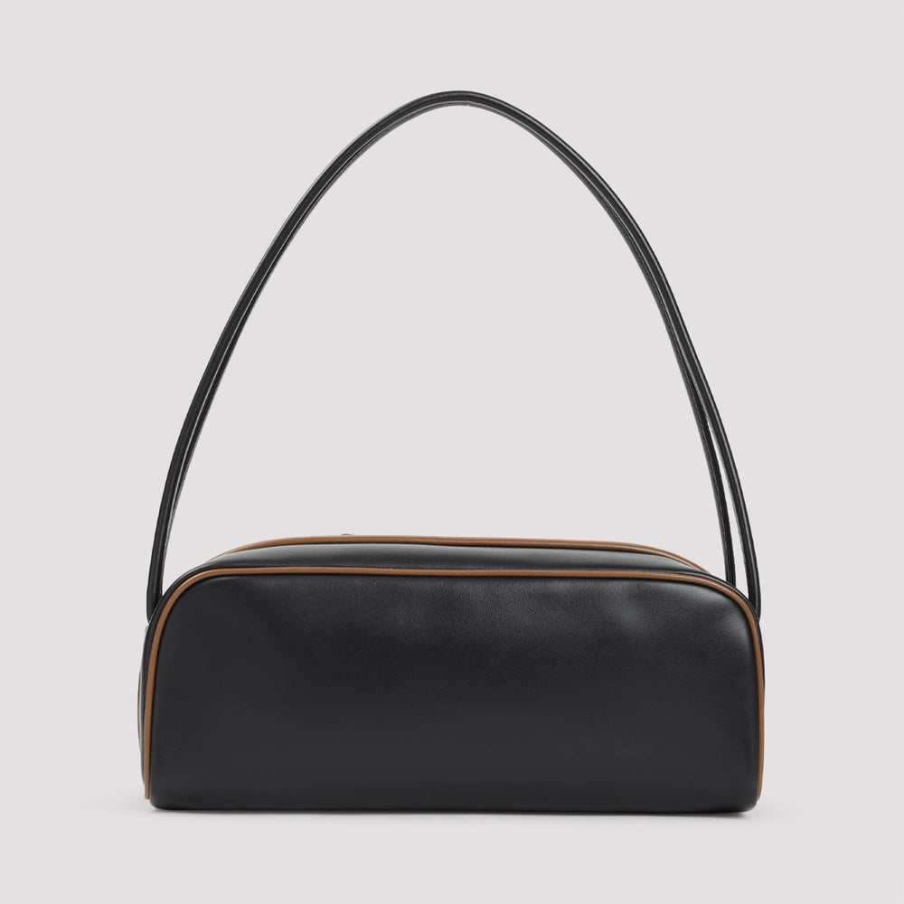 Black handbag with a curved handle on a light gray background
