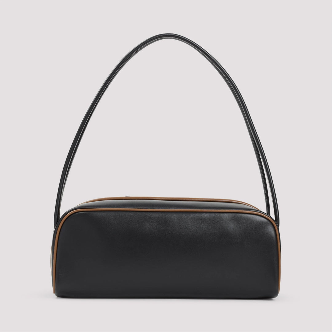 Black handbag with a curved handle on a light gray background