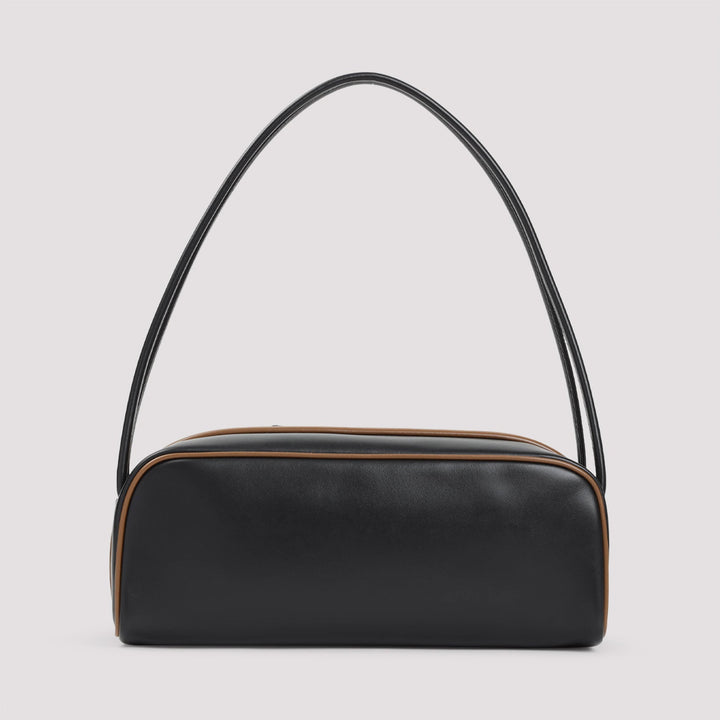 Black handbag with a curved handle on a light gray background