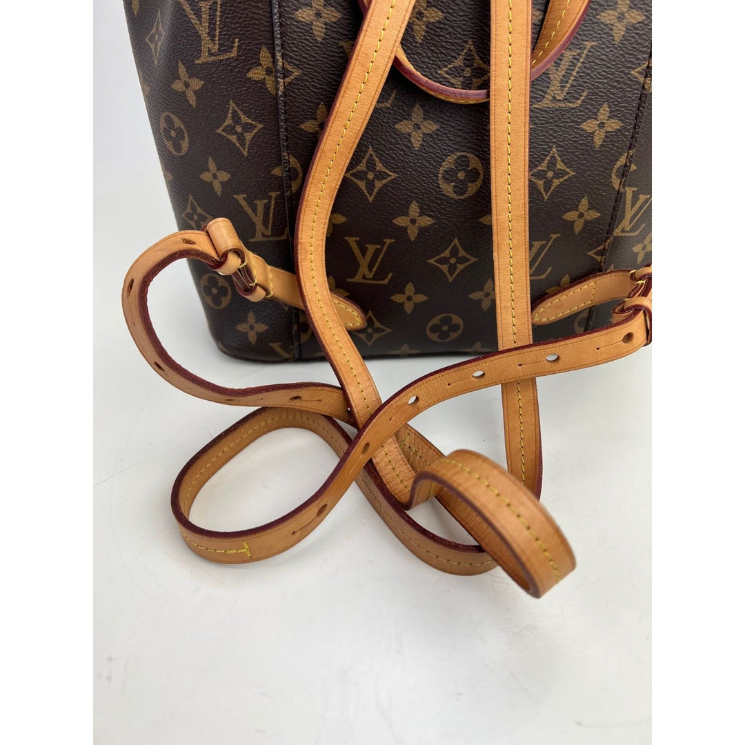 Close-up of leather straps on LOUIS VUITTON Montsouris NM Monogram Backpack, showcasing authentic luxury bag details.
