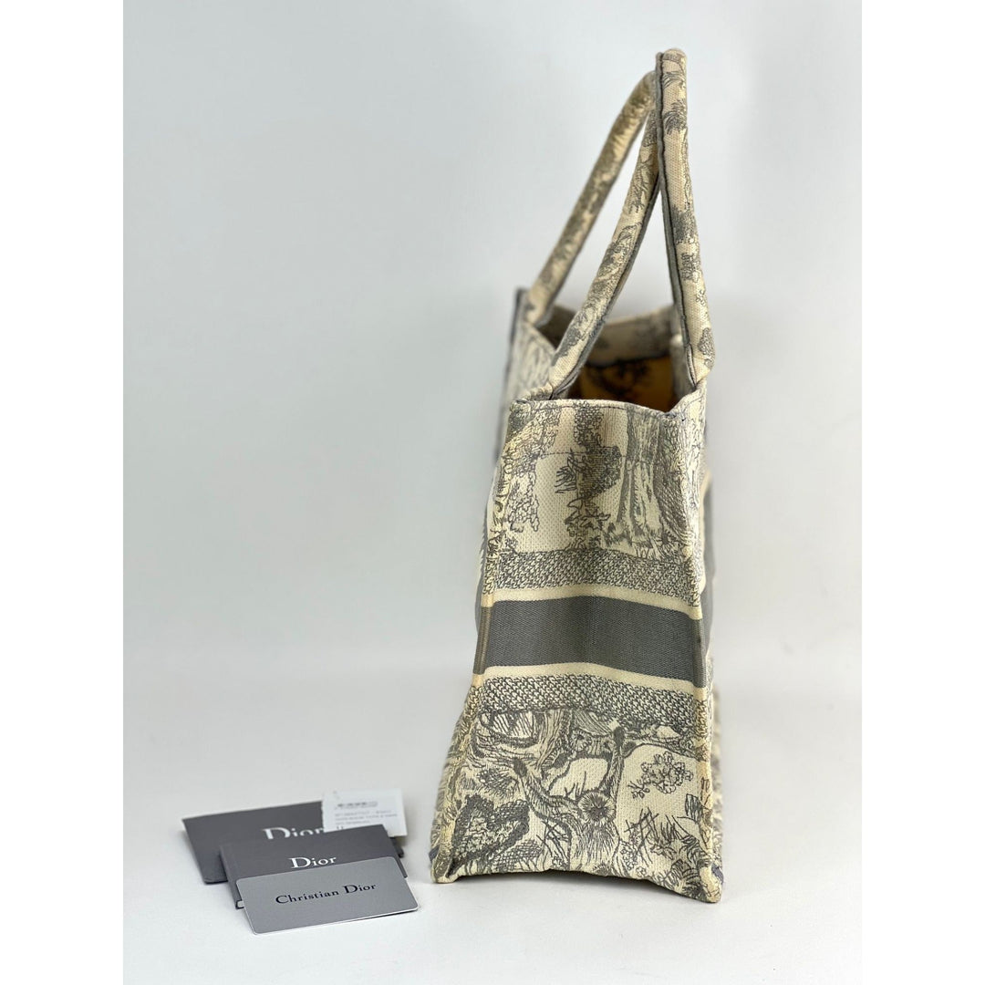 Designer handbag with 'Dior' cards on a white background