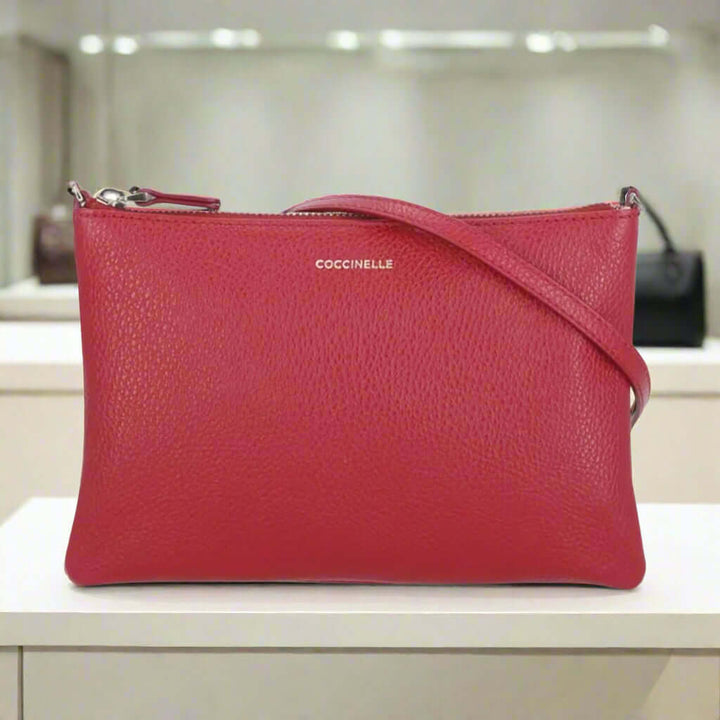 Red leather handbag with a visible brand logo on a white background