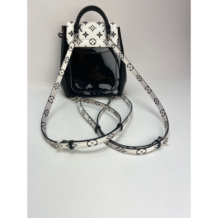 LOUIS VUITTON Hot Springs Backpack White Monogram and Patent Leather showcasing straps and design details. Luxury bags.