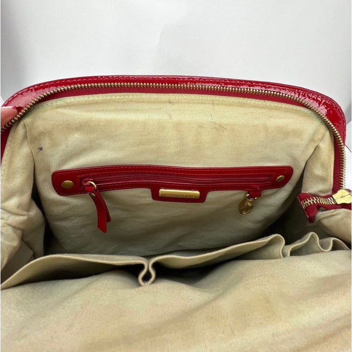 Interior view of Isabella Fiore Red Patent Leather Hand bag showcasing zipper pocket and tan lining, luxury bags.