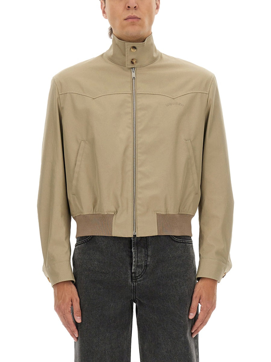 Beige jacket worn by a person on a white background