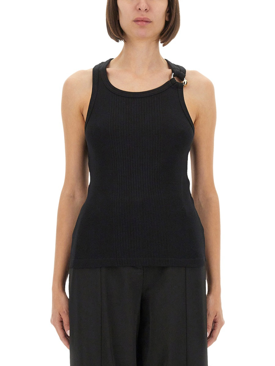 Person wearing a black sleeveless top with a subtle pattern on a white background