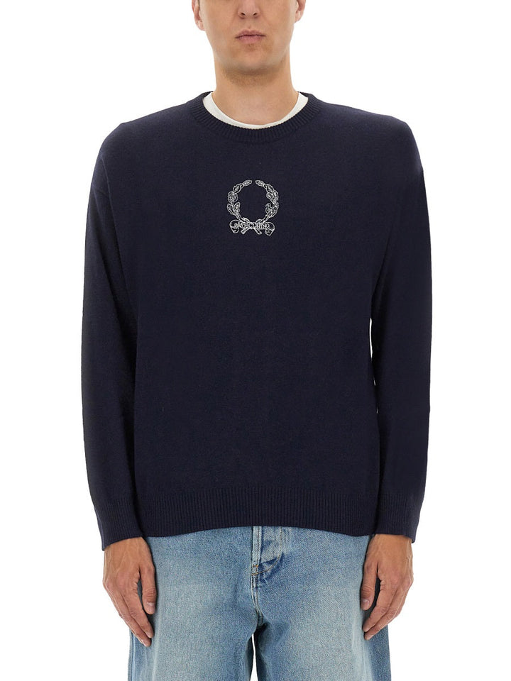Navy sweater with a logo worn by a person on a white background