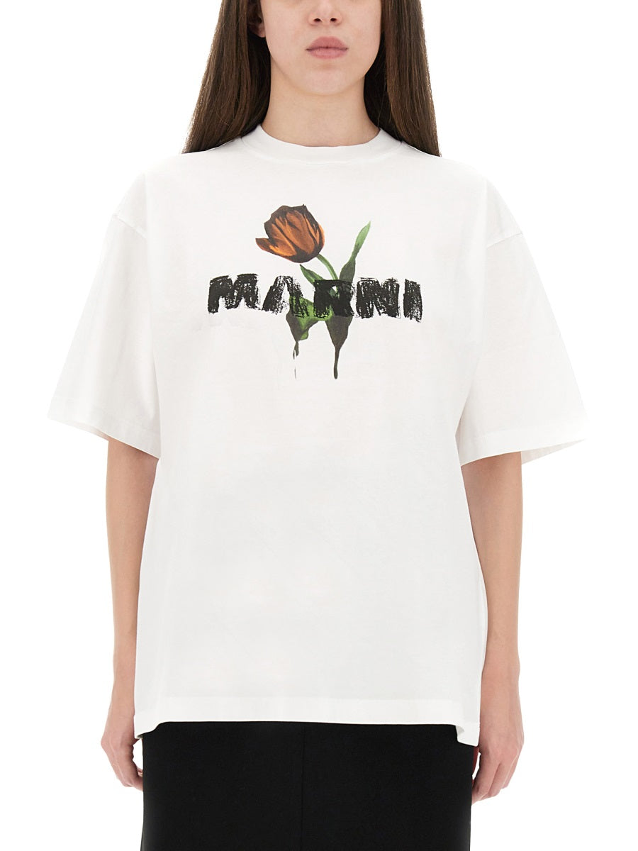 Person wearing a white t-shirt with a graphic design and text on a white background
