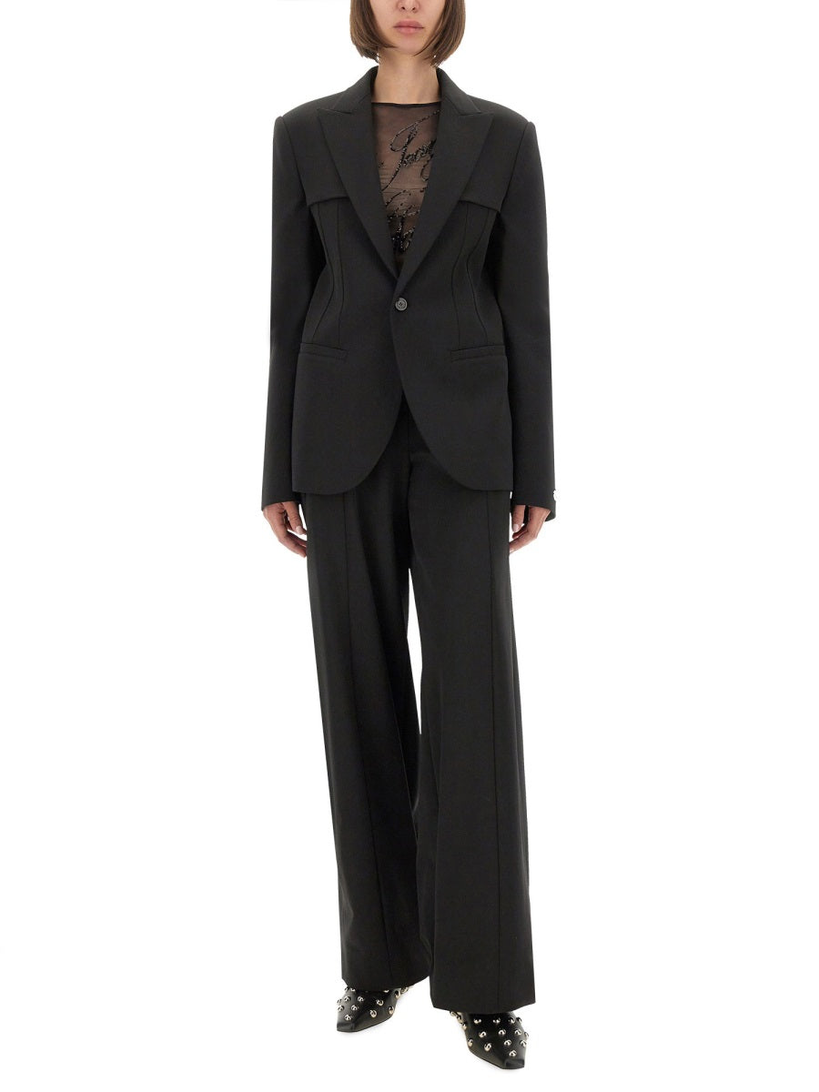 Person wearing a black suit with a white background