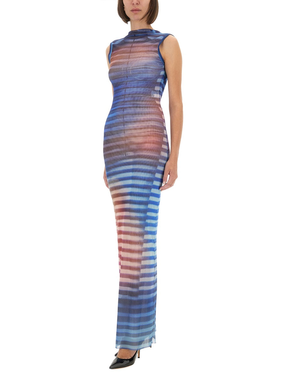 Woman wearing a long, sleeveless dress with blue and pink gradient on a white background