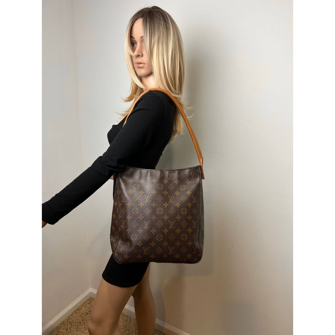 Model showcasing LOUIS VUITTON Looping GM Monogram Shoulder Bag, a luxury bag with iconic monogram design.