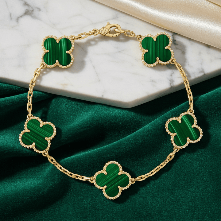 Van Cleef & Arpels Vintage Alhambra bracelet, 5 motifs 18K yellow gold, Malachite on green fabric surface.