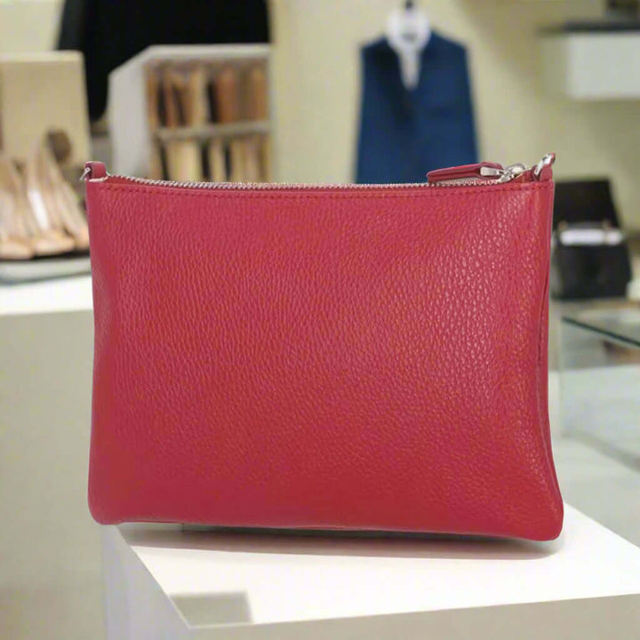 Red leather pouch with a zipper on a white background