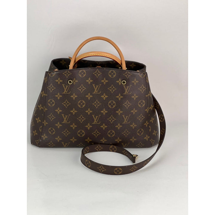 Brown handbag with monogram pattern on a white background