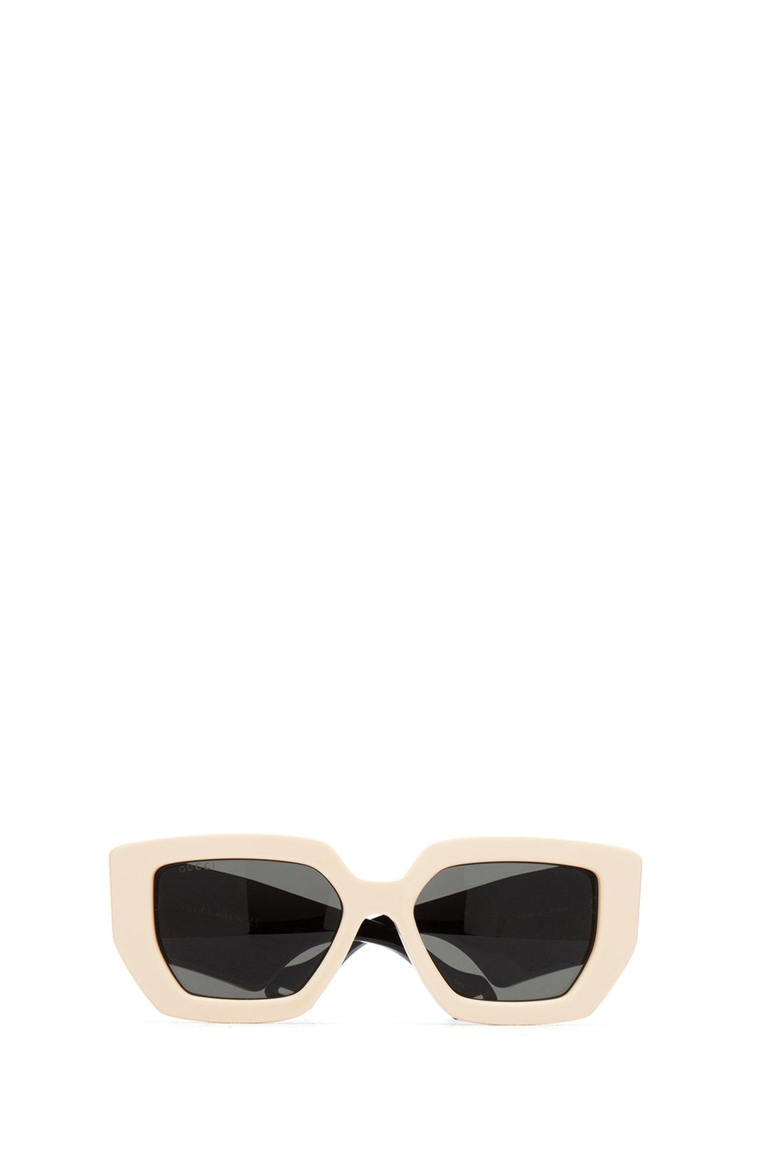Beige sunglasses with black lenses on a white background