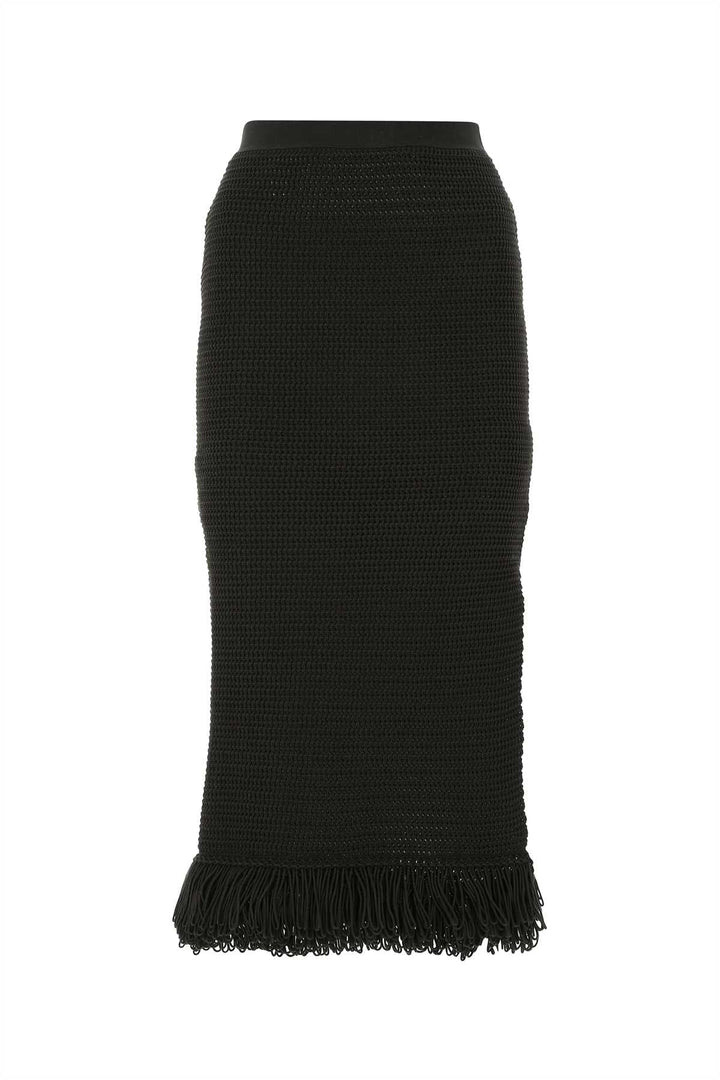 Black knit skirt with frayed hem on a white background