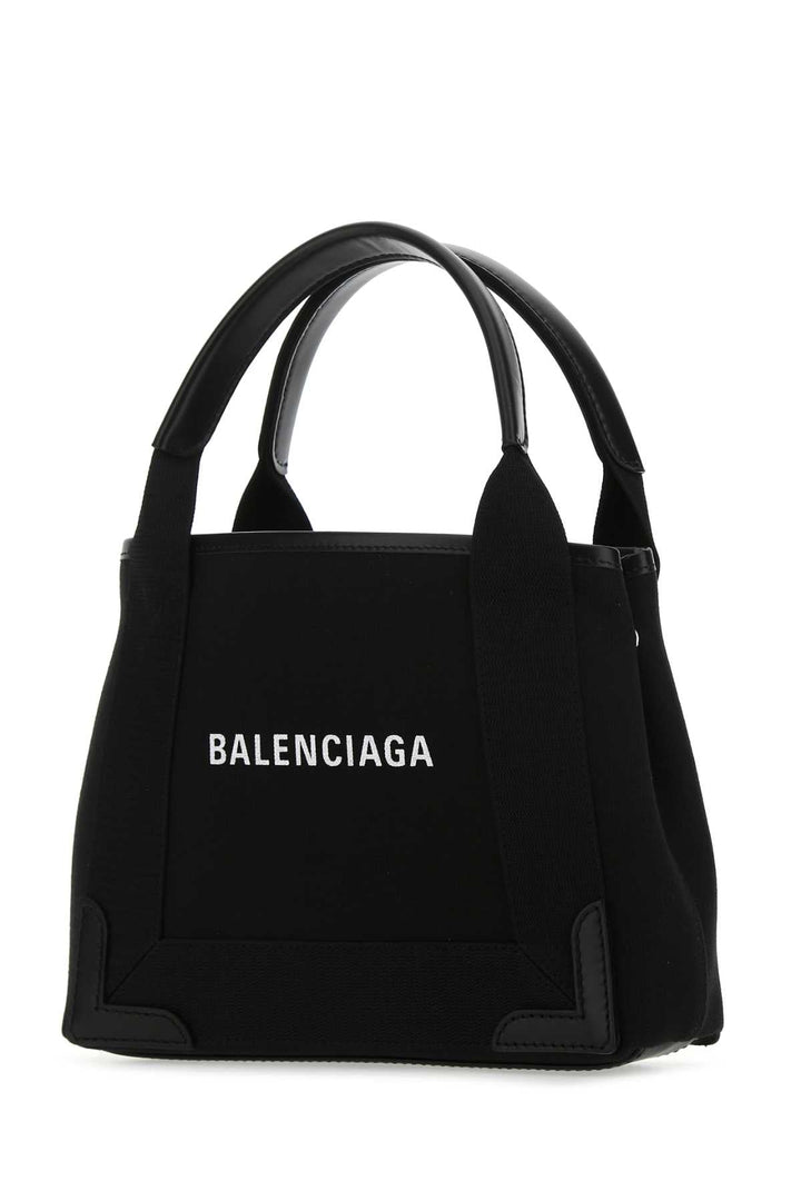Black Balenciaga handbag on a white background