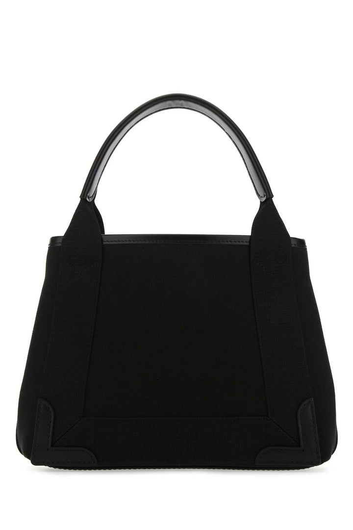 Black handbag with a metallic handle on a white background