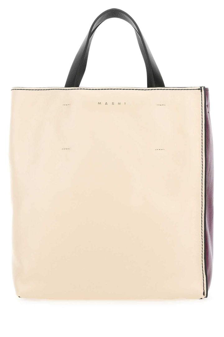 Beige tote bag with black handle on a white background
