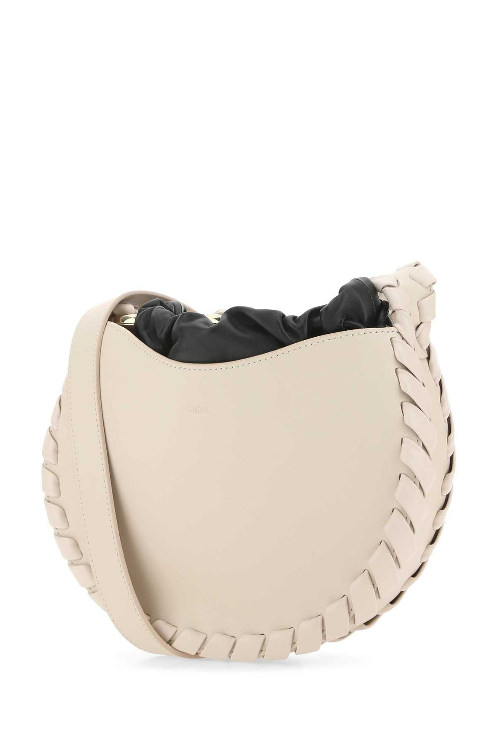 Beige leather saddle pad with black interior on a white background