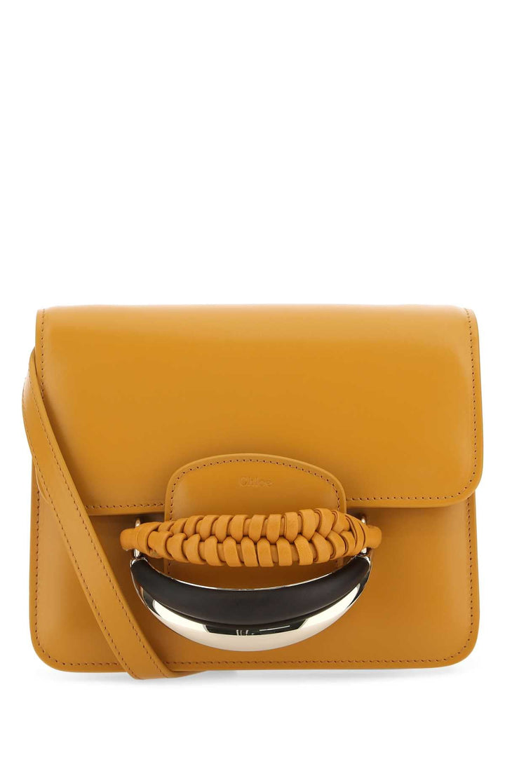 Yellow handbag with a braided handle on a white background