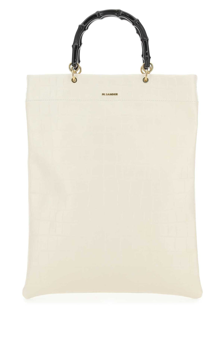 White tote bag with black bamboo handle on a white background