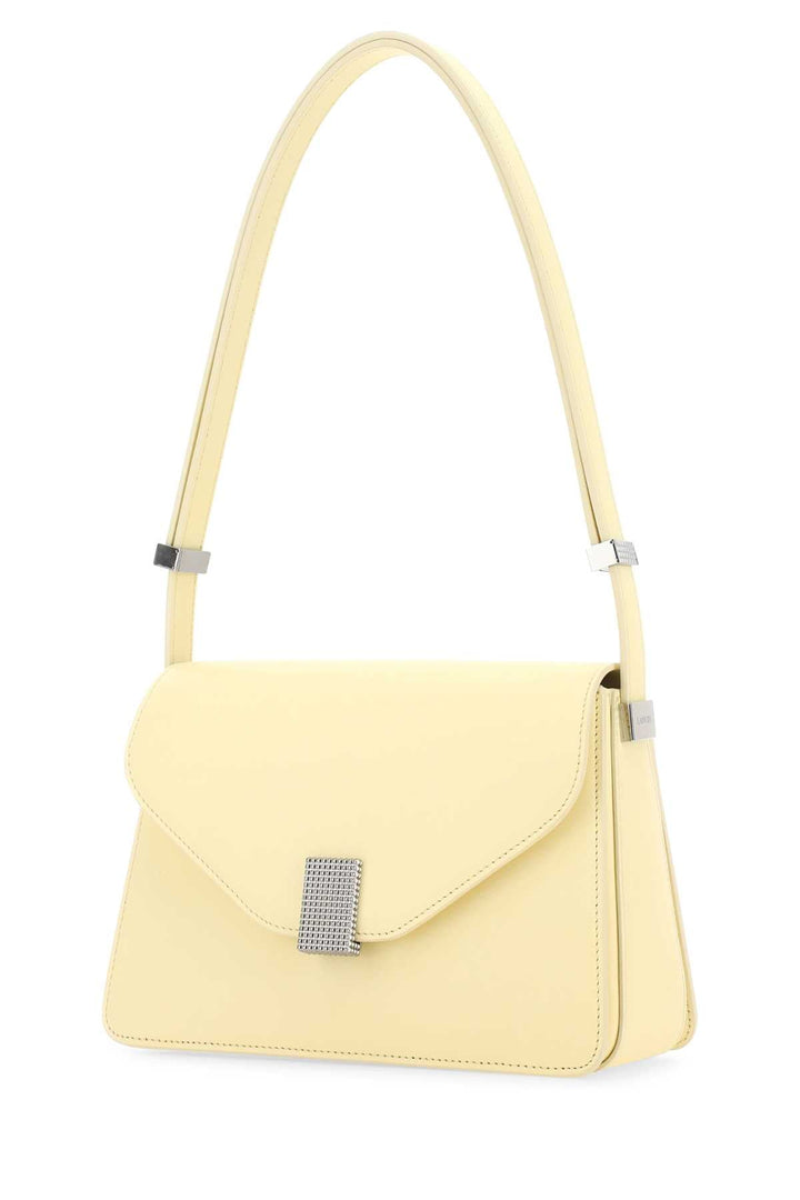 Yellow handbag with a decorative clasp on a white background
