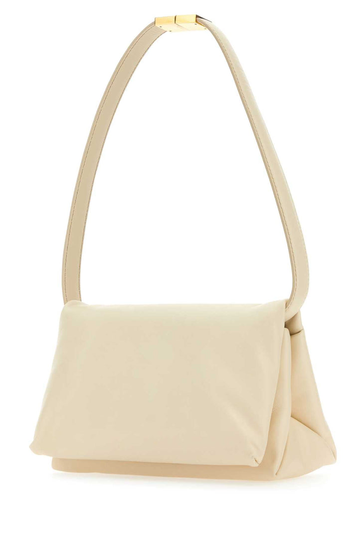 Beige handbag with a gold handle on a white background