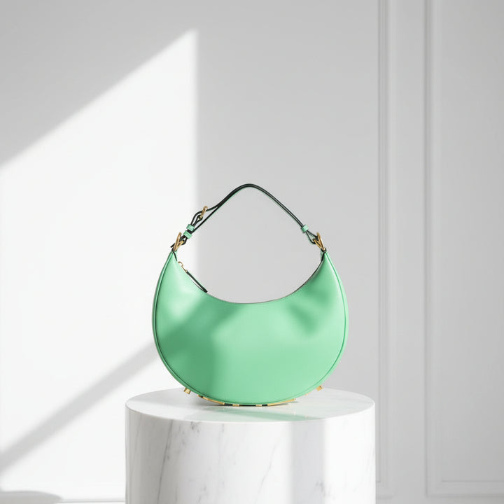 Green handbag with a black handle on a white background