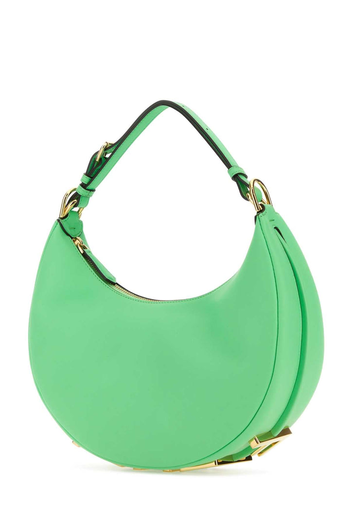 Green handbag with gold accents on a white background